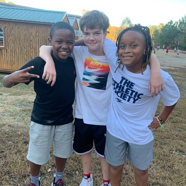 three boys posing for photo